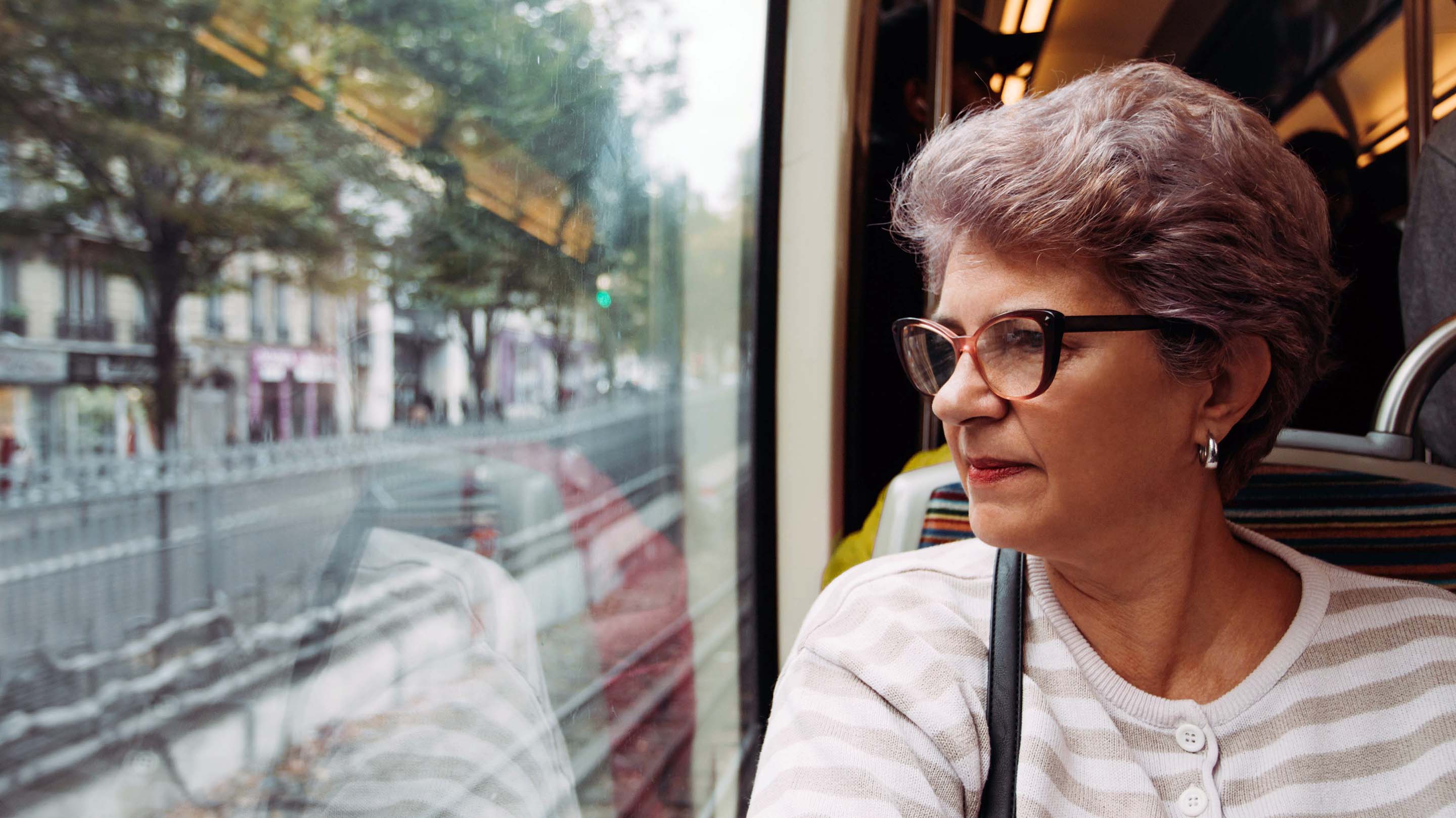 Older woman looking out of train window